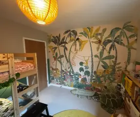 Children’s bedroom with jungle wall mural and bunk bed