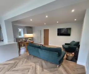 Open-plan living space with herringbone flooring in a home extension